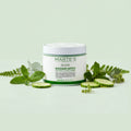 Jar of Marte's Detox Mask with mint leaves and cucumber slices on a light green background